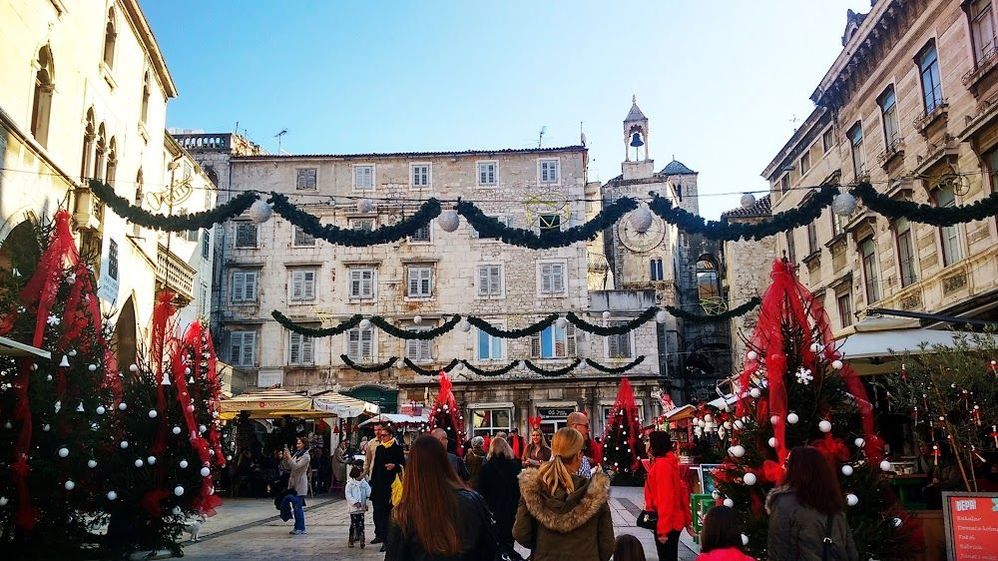 Caption: A photo of a square in Split, Croatia, decorated with Christmas trees and hanging garlands. (Local Guide Gojan Majkovic)