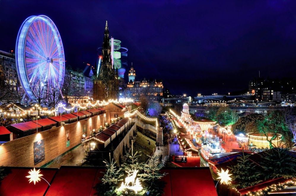 Caption: A photo of a Christmas market and a Ferris wheel decorated in colorful lights in Edinburgh, Scotland, UK. (Local Guide James Groot)