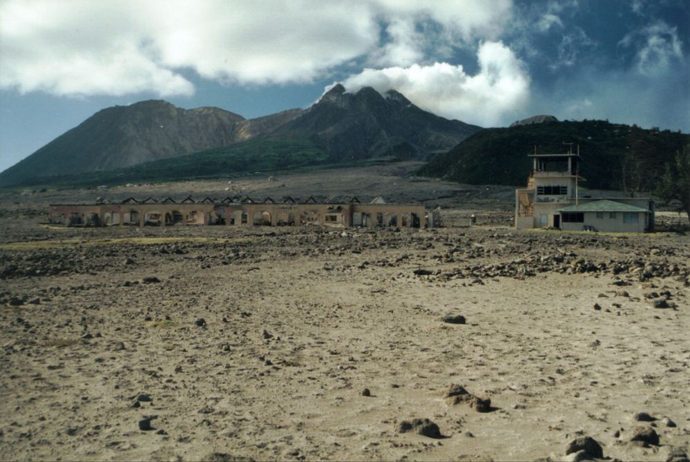 The remains of the airport with Soufrière Hills volcano in  the background