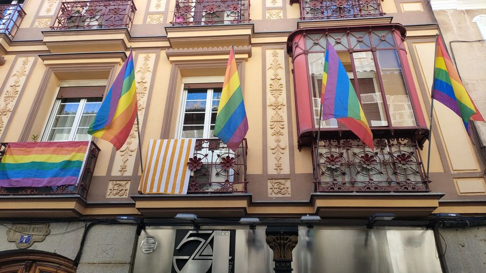 Caption: A photo of pride flags hanging from balconies in the Chueca district in Madrid, Spain. (Local Guide PIKI)