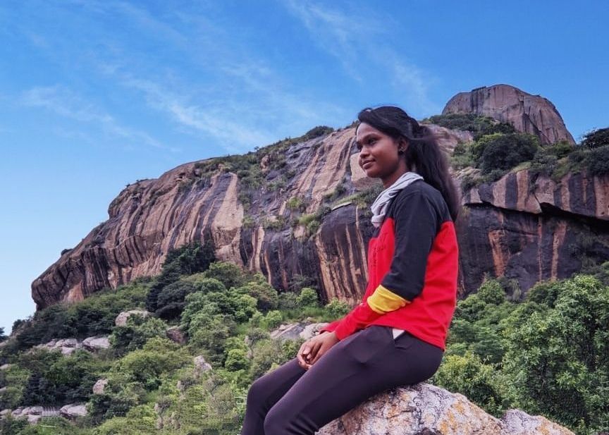 Caption: A photo of Ananya sitting on a rock and looking in the distance. (Local Guide @Passiontracker)