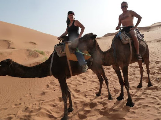 Caption: Local Guide @AdamGT and partner on camels in the Sahara Desert