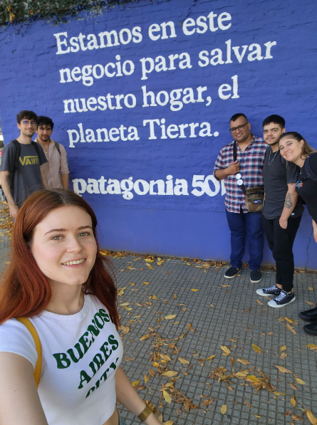 Caption: A mural with us taking a selfie around it. The mural says:
