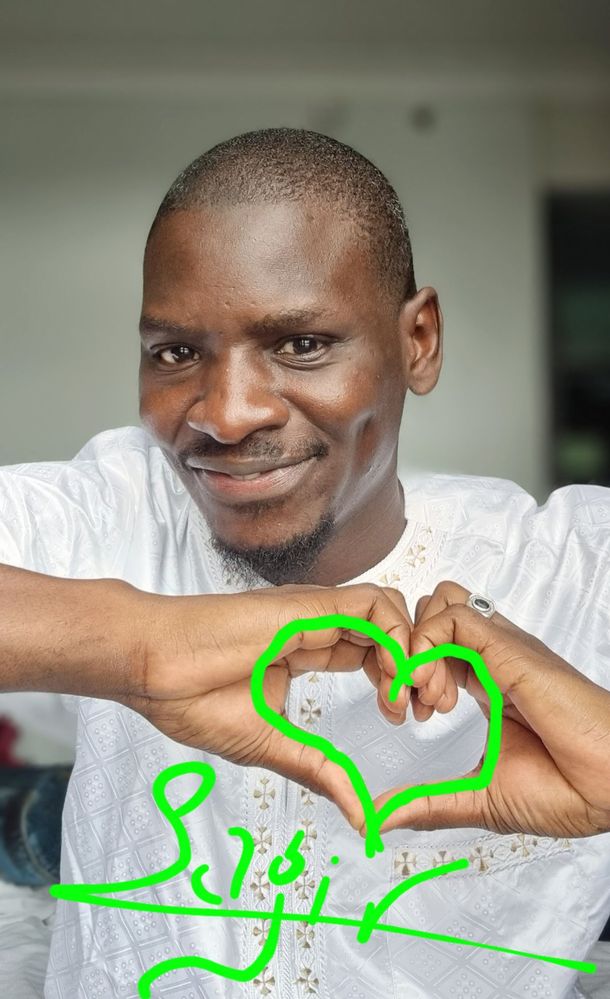Sagir indicating a heart sign with his hand.