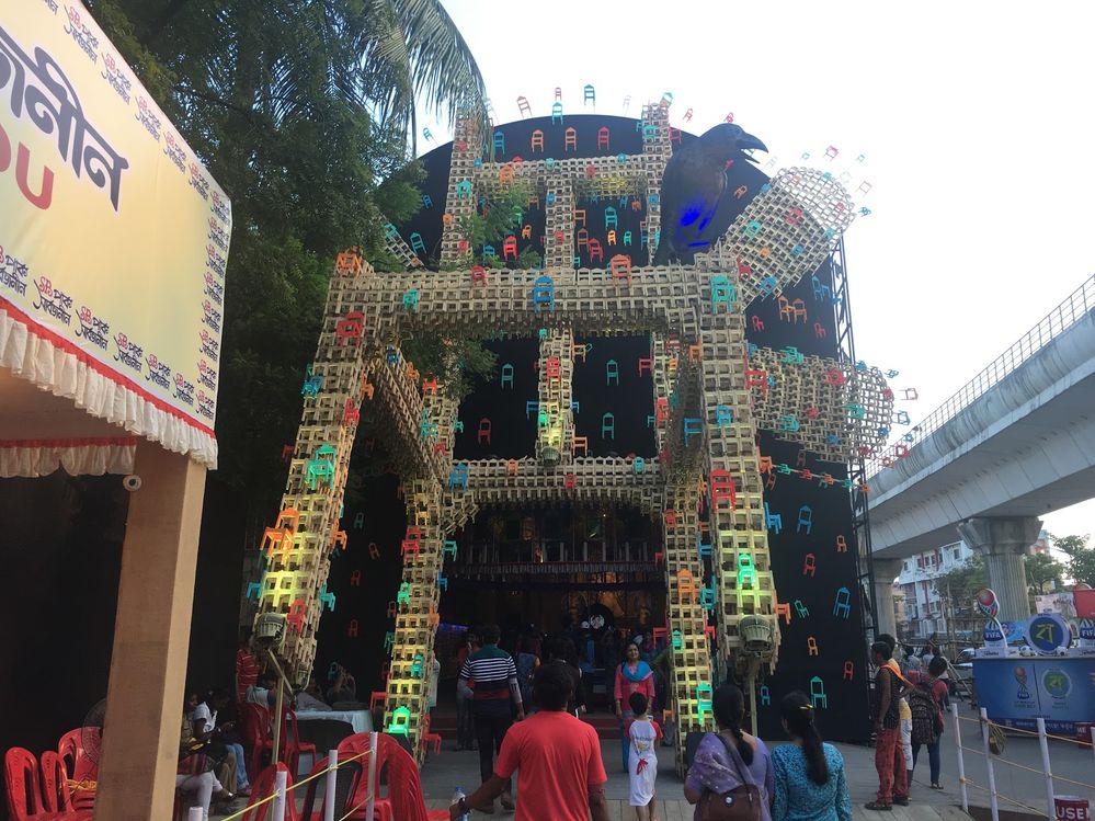 Caption: Pandal featuring a giant chair made of smaller chairs