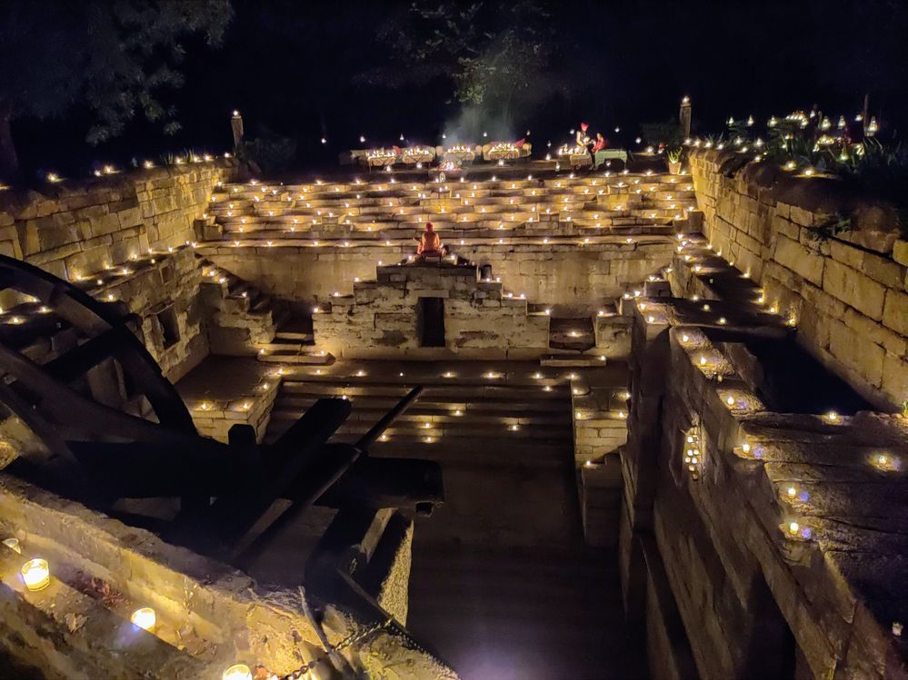 A stepwell decorated with dim light oil lamps