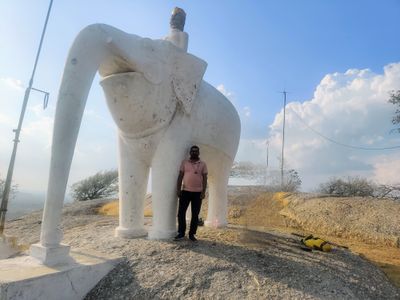 LG Nandkk under an elephant statute at a hilltop