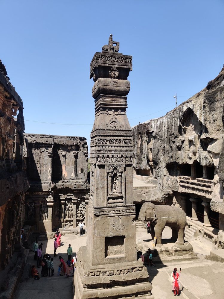 A towering of kailasa temple with a a statue of elephant with broken trunk