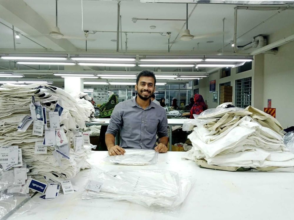 Caption: A photo of Shahinur Islam smiling while at work at a garment factory in Dhaka, Bangladesh. (Local Guide @shahinurime)