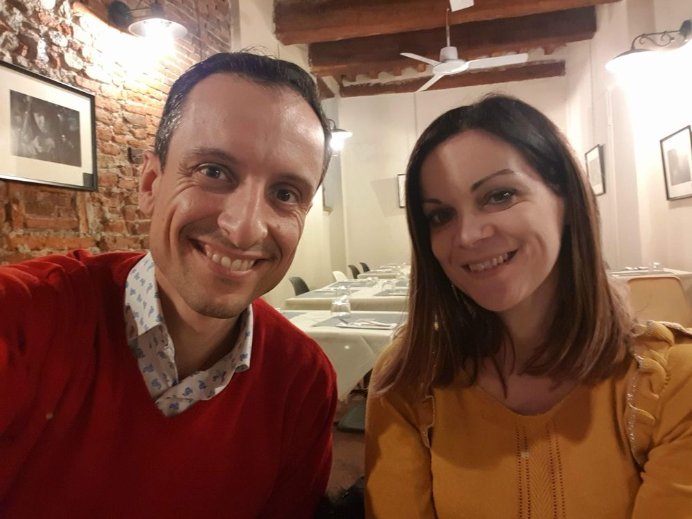 Caption: A selfie of Local Guide Luigi and his wife smiling while enjoying dinner at Pizzeria SUD in Lucca, Italy. (Courtesy of Local Guide @LuigiZ)