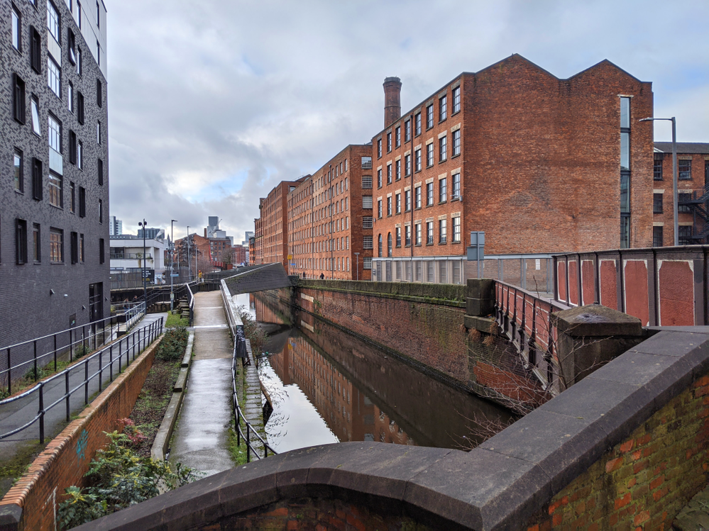 Caption: the canal network expanded rapidly and allowed access to industrial scale cotton mills and warehouses - as seen in this picture.