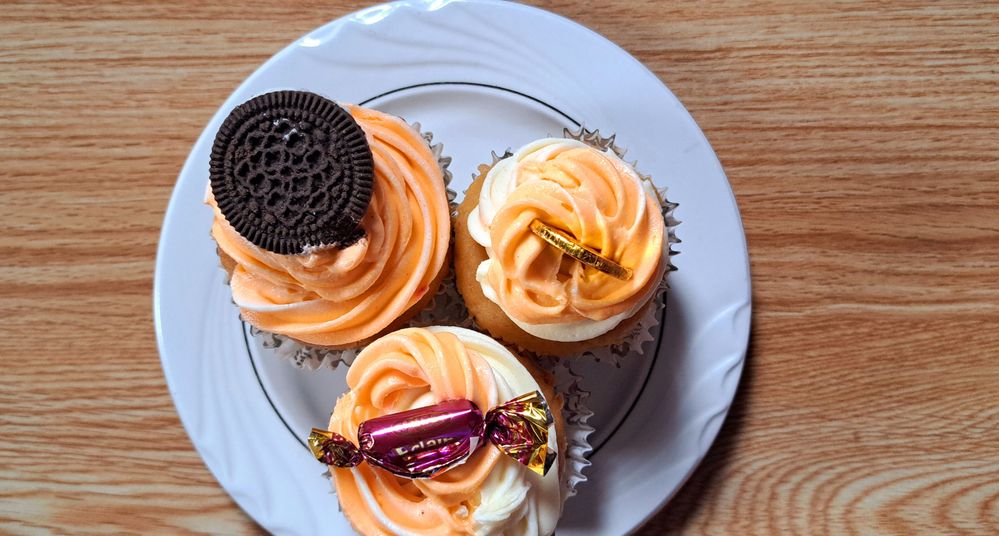 Caption: A photo of three cupcakes on a saucer. SholaIB
