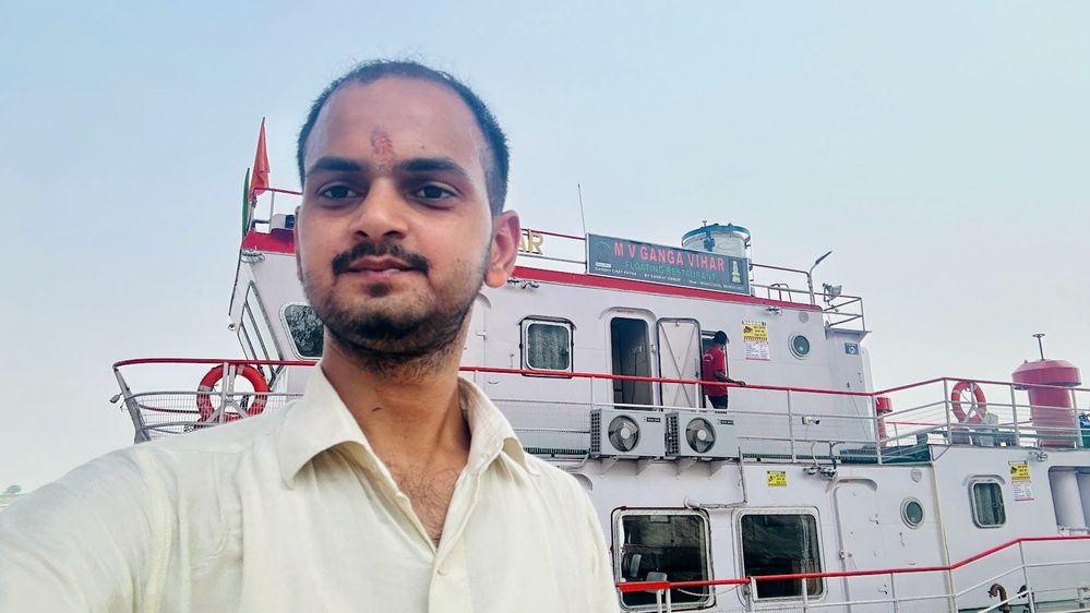 Caption: A photo of Ravi in front of a floating restaurant in India. (Local Guide @RaviSharma111)
