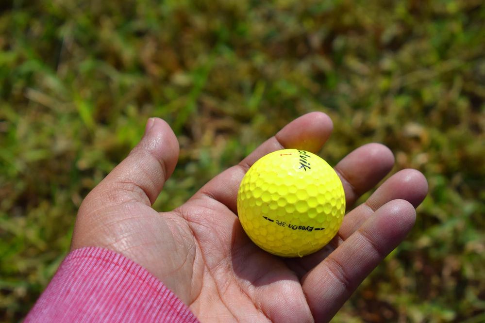Golf ball in my hand, it was dropped in front of me when I was taking rest in the place of gala night event. It was came with the wrong shot of a player, which was very very dangerous for me but luckily I was safe.