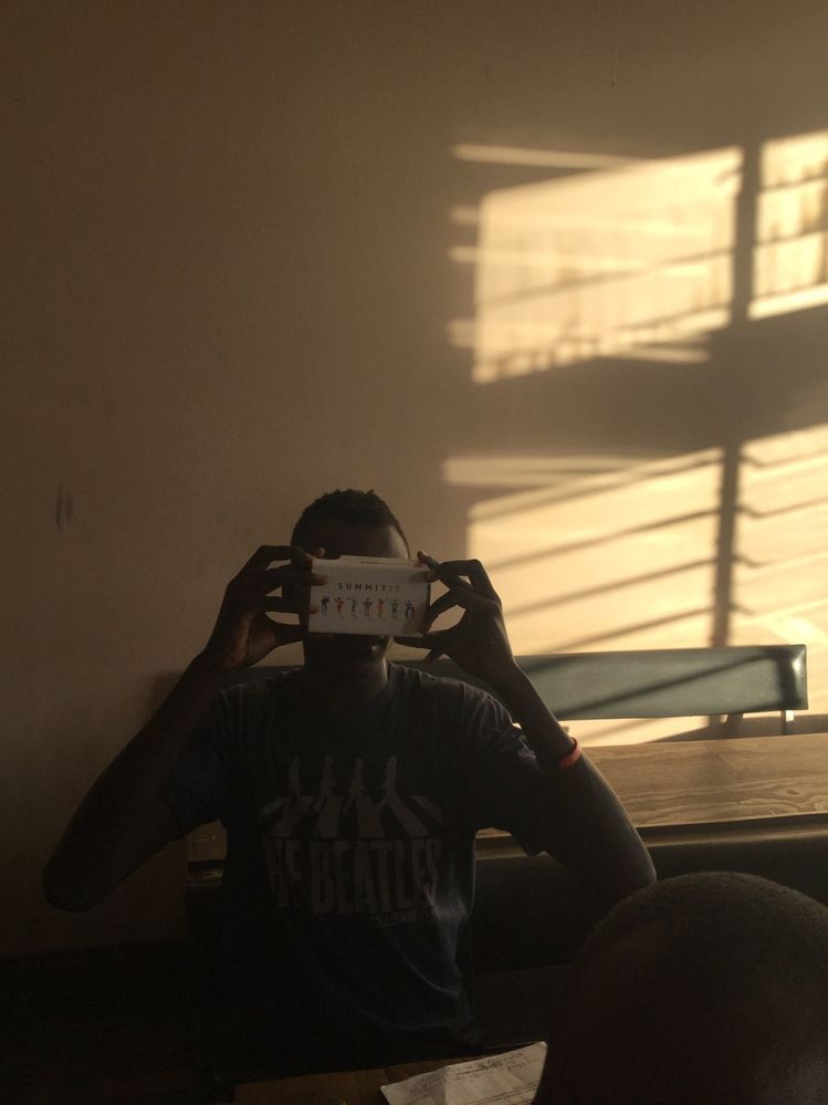 A Student experiencing VR  through the Google cardboad