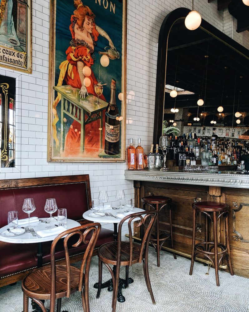 Caption: Empty tables inside Boucherie, a Parisian-styled restaurant in New York.