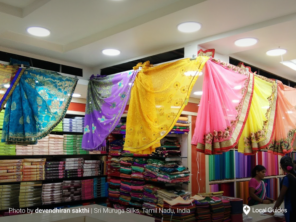 Caption: A colorful assortment of patterned silk hanging in a fabric store in Tamil Nadu, India.