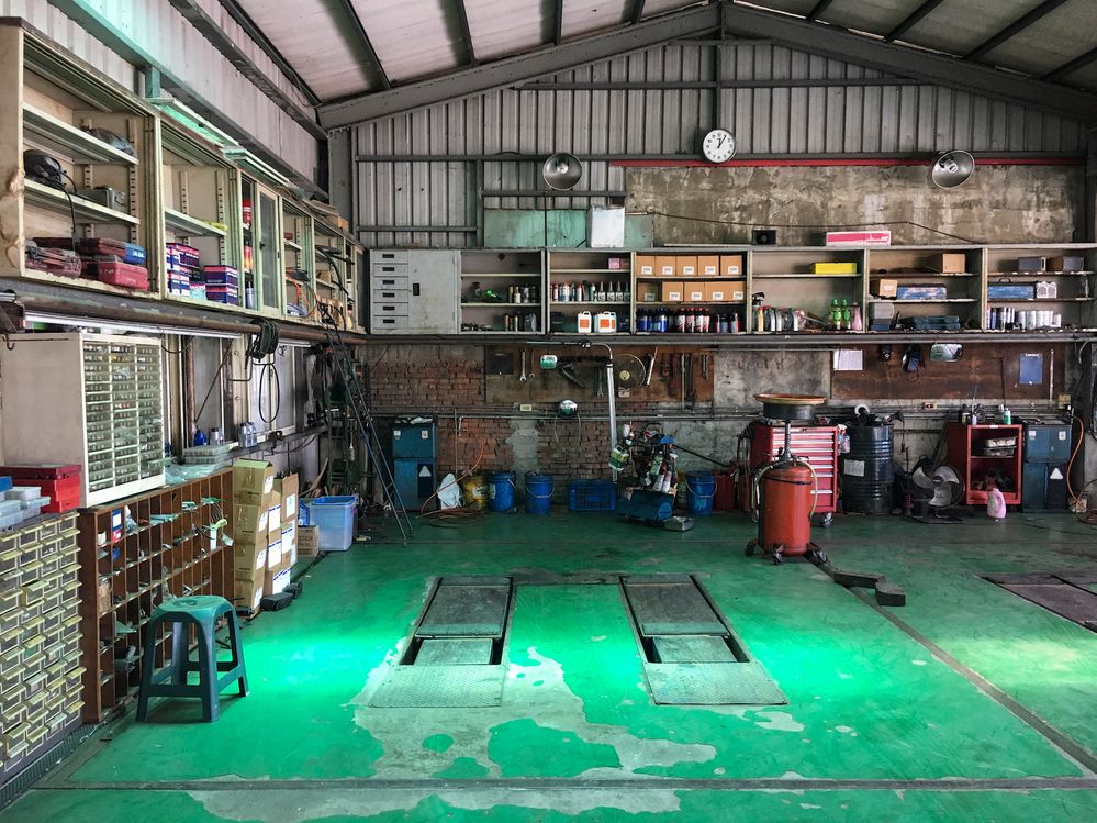 A mechanic's garage with a colorful green floor. (Getty Images)