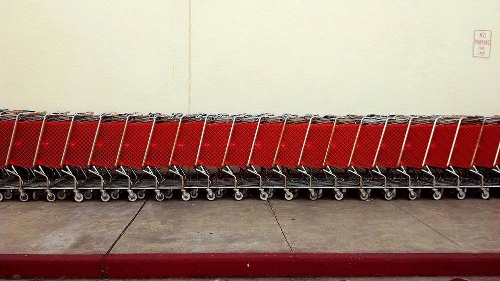 A row of red shopping carts outside of a store. (Getty Images)