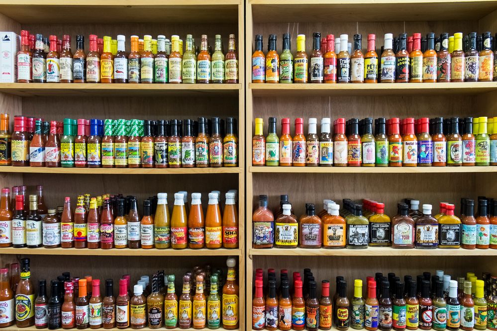 Several types of hot sauce sitting on a shelf in a Grocery Store. (Getty Images)