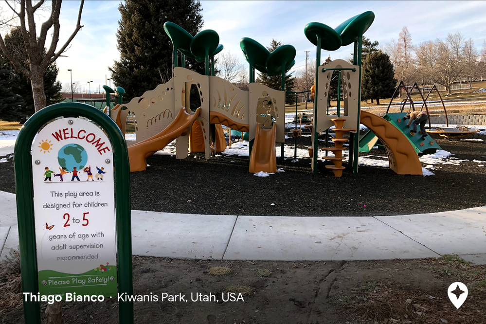 Caption: A photo by Local Guide thiago bianco of a playground with slides and swings in Utah that has a sign in front noting that the park is designed for children ages 2 to 5 years old with adult supervision recommended