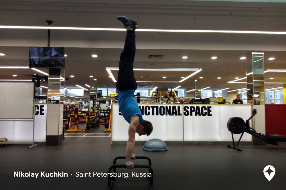 Caption: A photo of a man using gym equipment to do a handstand in a gym in St. Petersburg, Russia (Local Guide Nikolay Kuchkin)
