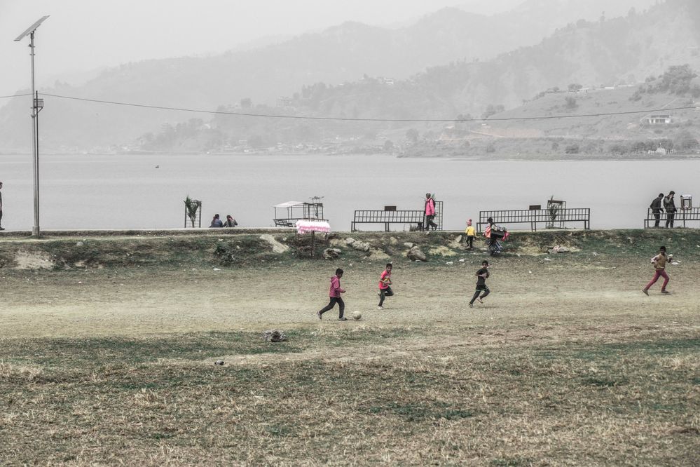 Kids playing in the bank of Phewa Lake