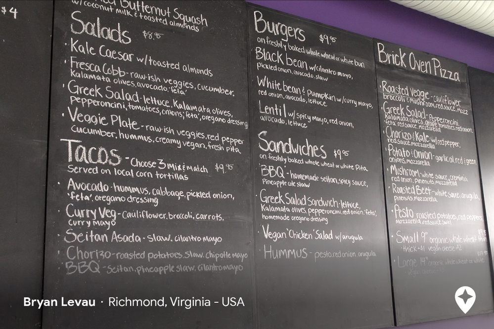 Caption: A photo of the menu at Fresca on Addison in Richmond, Virginia written on a large chalkboard with options like salads, tacos, meat-free burgers, sandwiches, and brick-oven pizza (Local Guide Bryan Levau)