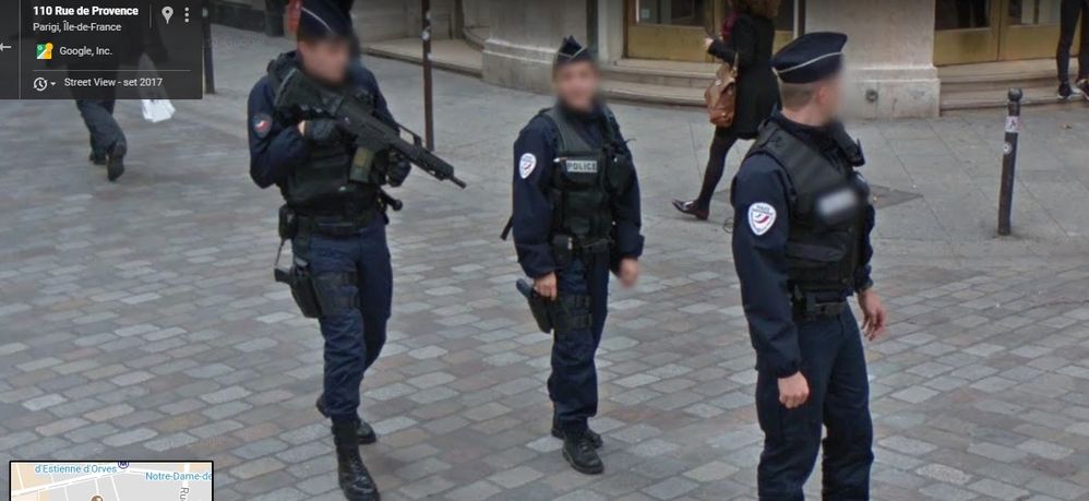 three policemen on patrol in the center of Paris
