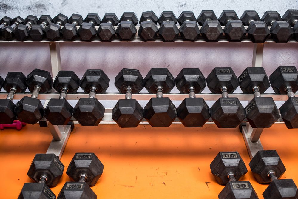 Caption: A photo of rows of dumbbells of various weights at a gym. (Getty Images)