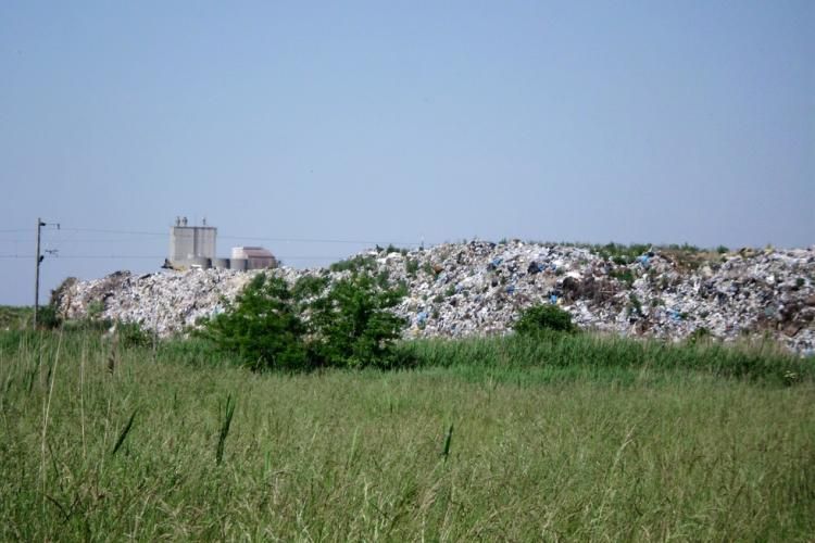 Landfill in the middle of a meadow near the city