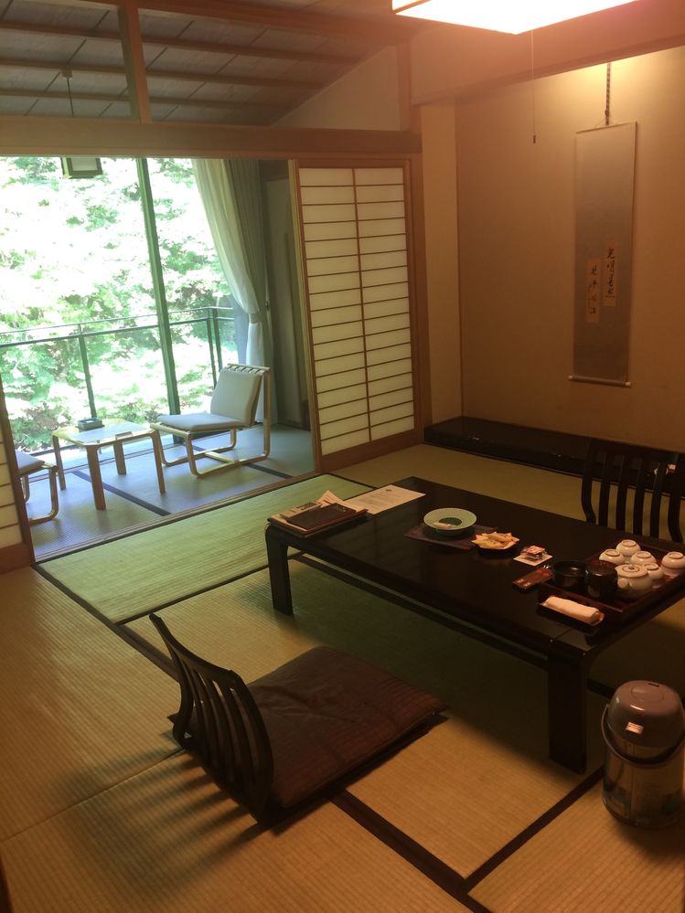 A view of inside the room with tatami floors and a low table.