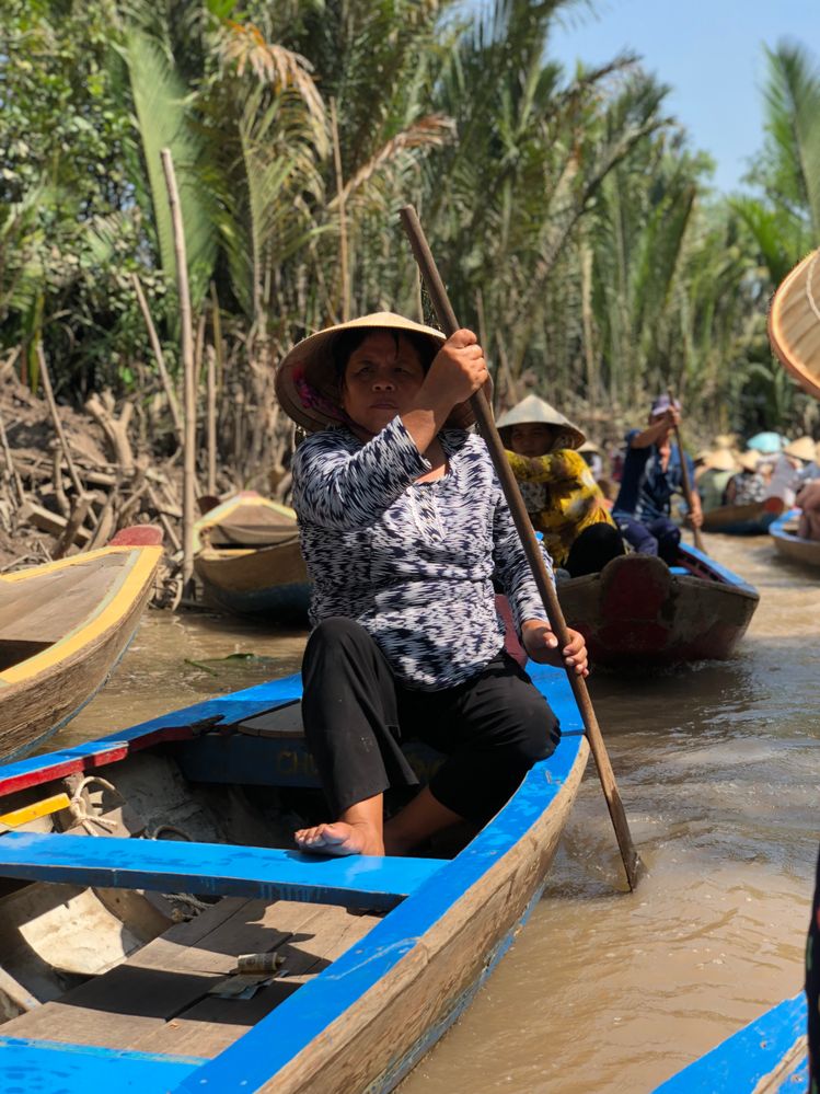 During the Mekong Delta trip, you get to cruise through a narrow canal in these boats. The rowing is done predominantly by local ladies.
