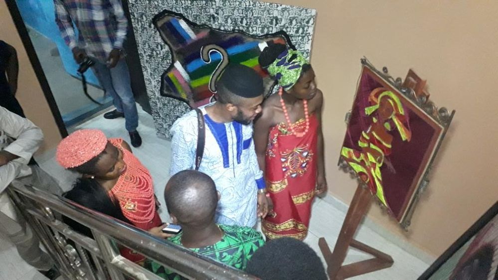 Awka local guides admiring some traditional art works