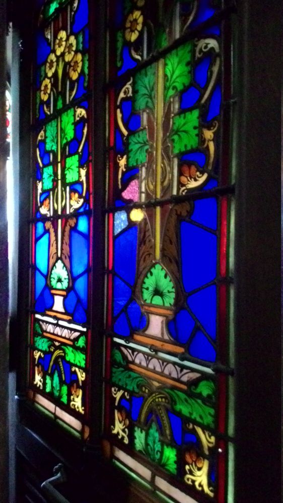 A stained glass window hidden by a door