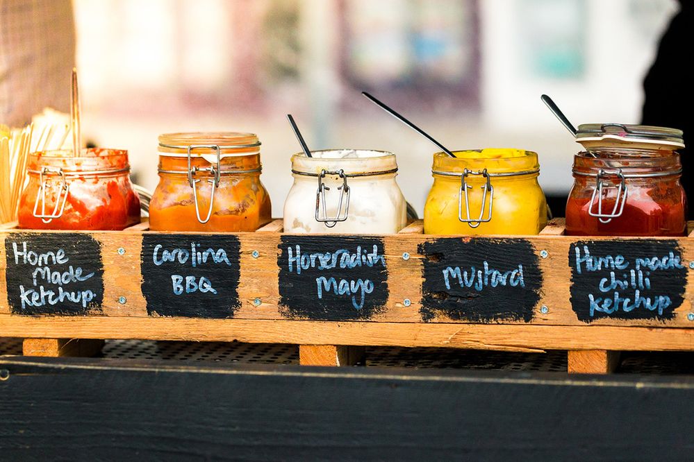 Caption: A photo of a variety of condiments in glass jars on a counter. (Getty Images)