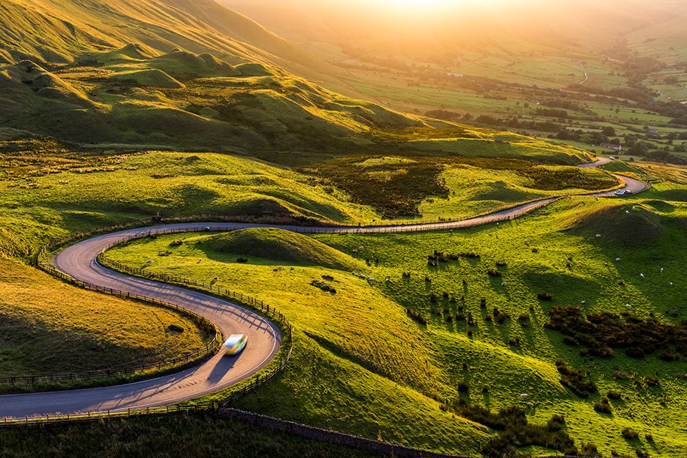 Caption: A photo of a winding road through the countryside in Peak District National Park in England. (Getty Images)
