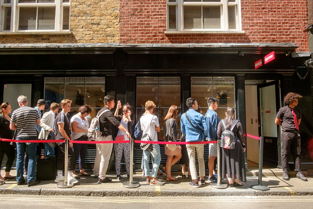 Caption: A photo of a line of people waiting outside of the store Supreme in London. (Local Guide Scott Hortop)