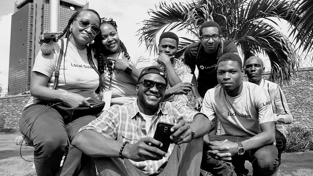 Black and white image of Emeka (top right with glasses) and fellow Local Guides at a meet-up.