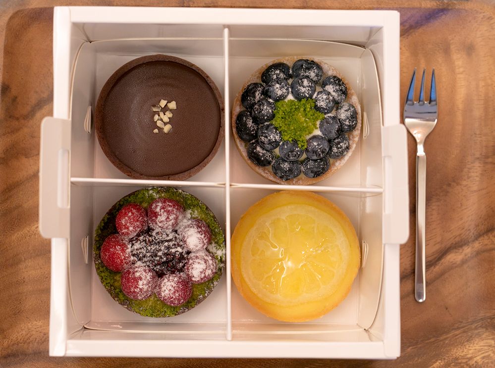 Caption: A photo of a variety of pastries in a square box. (Getty Images)