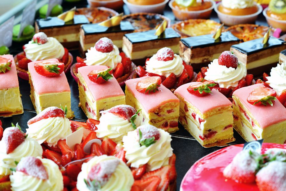 Caption: A photo of sweet desserts in rows in a bakery display. (Local Guide André Szep)