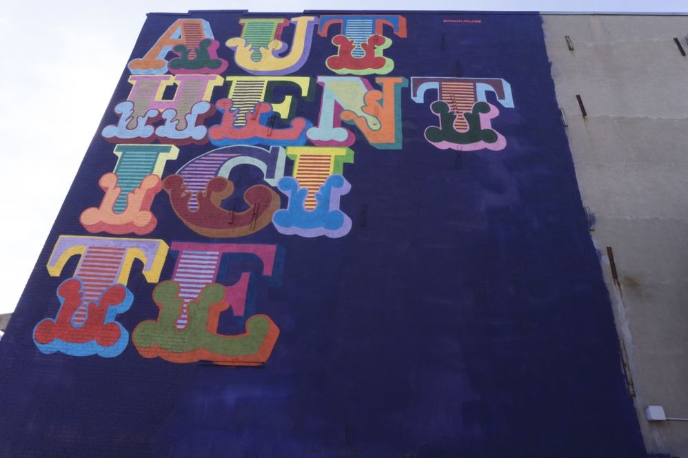 Caption: A photo of a colorful mural created by UK-based artist Ben Eine that says “authenticité.” (Courtesy of MURAL Festival)