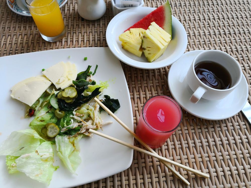 Caption: A photo of a salad, juice, fruit, and coffee taken at Meliá Bali in Bali, Indonesia. (Local Guide Medoo Fit)