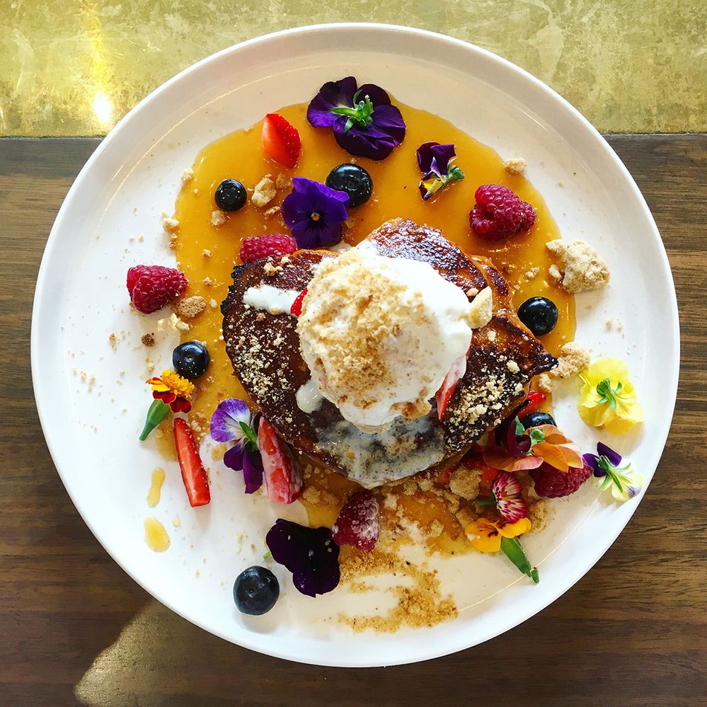 Caption: A photo of a plate of French toast topped with mascarpone mousse, berries, and edible flowers at Darling Cafe in Melbourne, Australia. (Local Guide Naomi Fouquet)