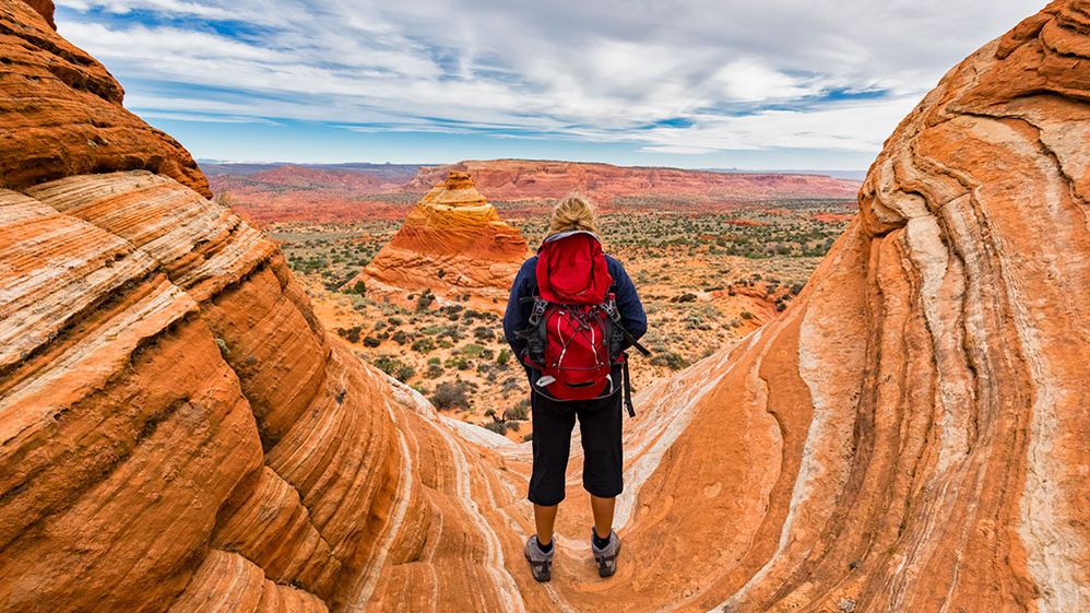 Caption: A photo of the back of a person hiking in Paria Canyon in Arizona, United States. (Getty Images)