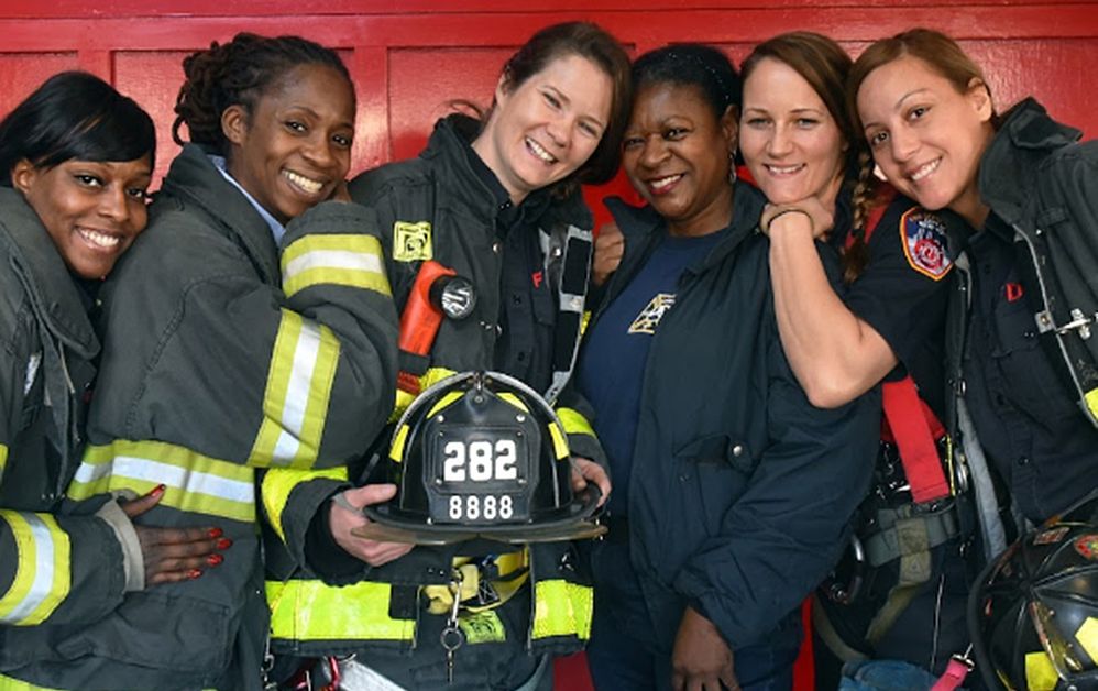 Caption: A photo of a group of female firefighters from the Fire Department of the City of New York.