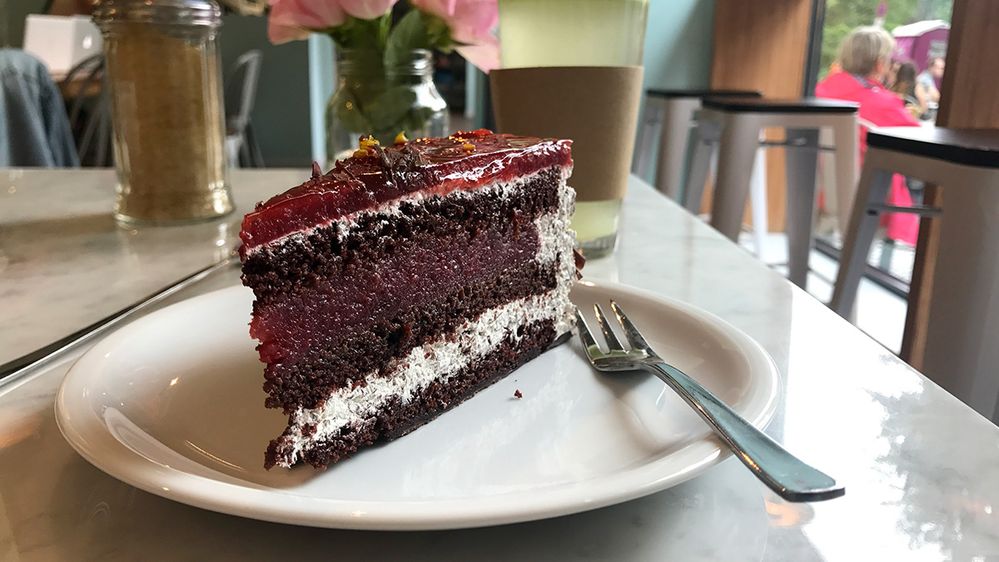 Caption: A photo of a slice of black forest cake on a plate with a fork next to it. (Local Guide Maximilian Beyer)