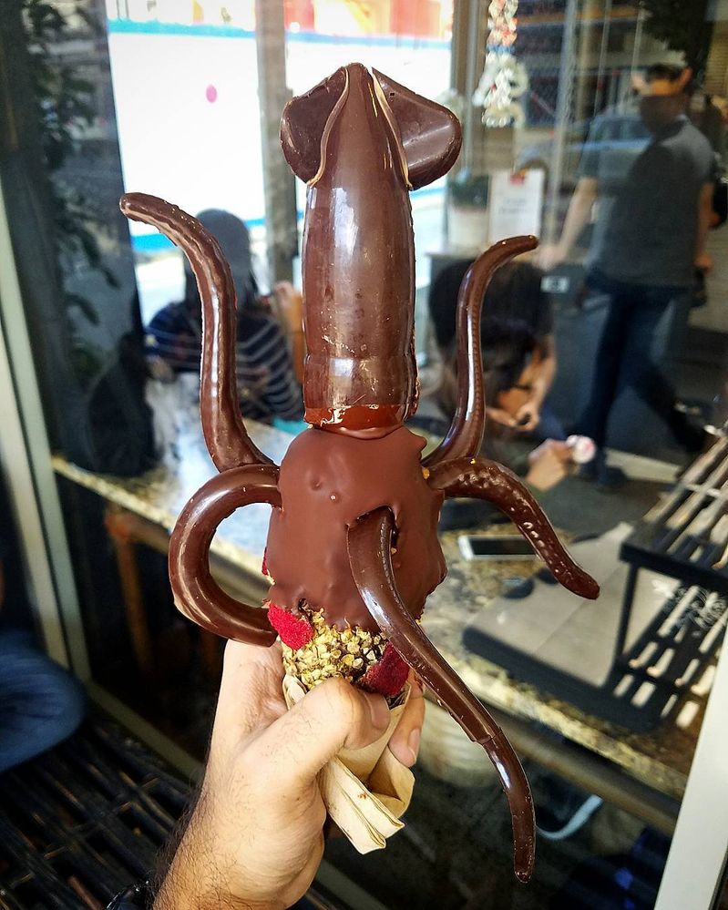 Caption: A photo of New Zealand ice cream shop Giapo’s “The Colossal Squid.” The dessert consists of an ice cream cone dipped in chocolate, nuts, and dried fruit with large chocolate pieces in the shape of a squid attached to the ice cream. (Local Guide Mohit)