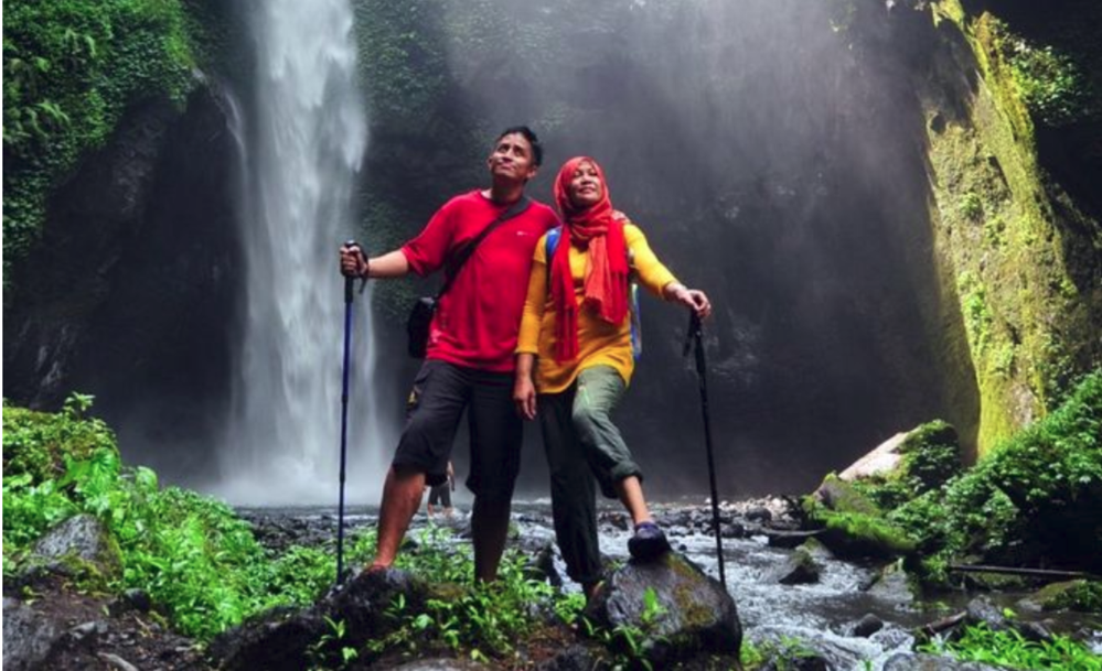 Caption: A photo of Local Guides in front of a waterfall in Coban Jodo in East Java, Indonesia. (Local Guide @NunungAfuah)