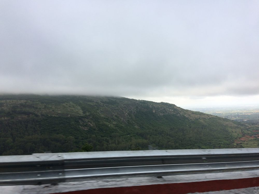 While coming down: watch the clouds touching hills: foggy cloud